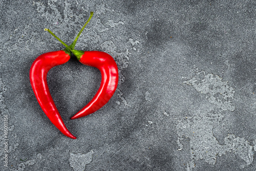 Red cili pepper heard on grey background