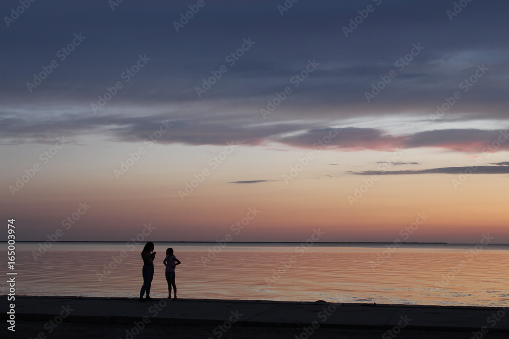 Girls at the sea in the evening