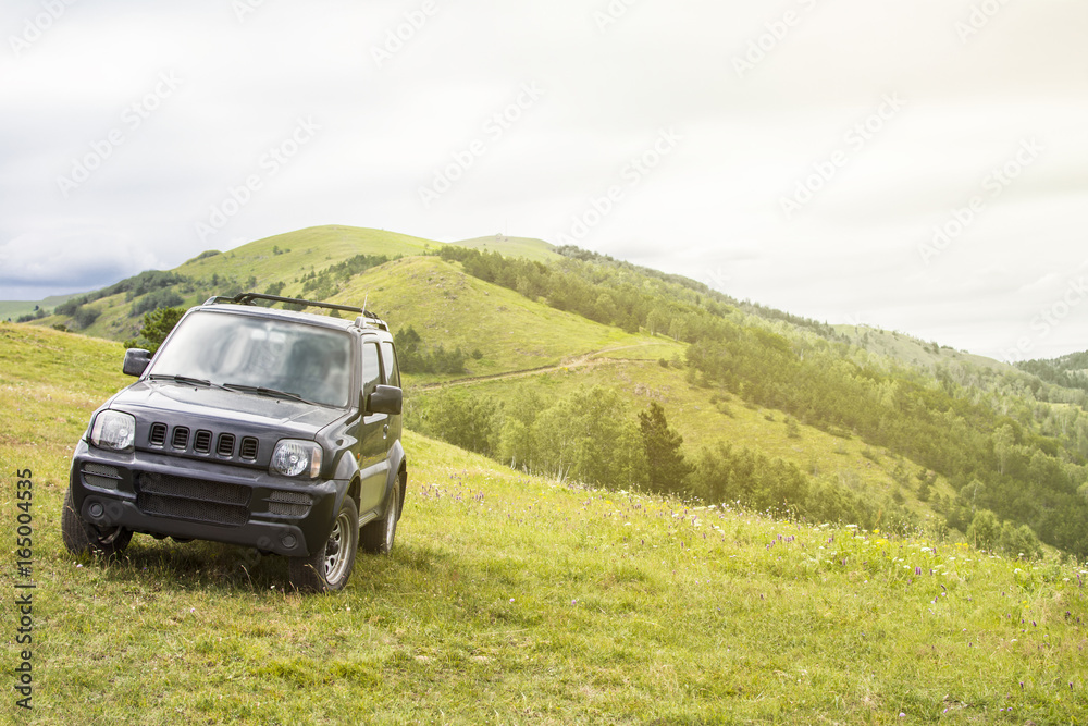 Green mountain landscape. Car parked on a mountain top. Green mountain landscape. Car parked on a mountain top.
