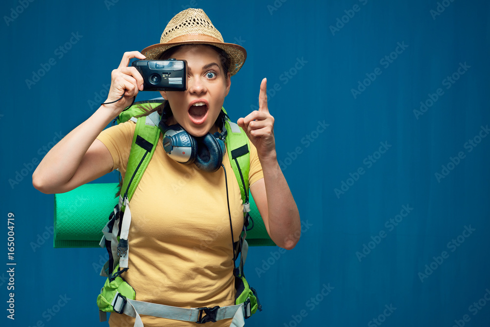 Surprising woman traveler taking pictures with photo camera Surprising woman traveler taking pictures with photo camera