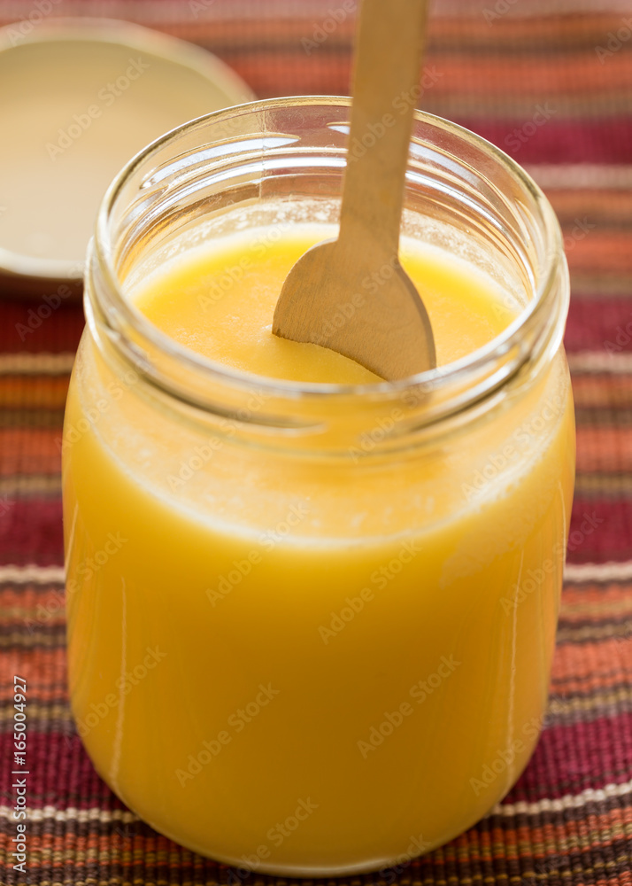 Ghee - clarified butter - in a glass jar Ghee - clarified butter - in a glass jar