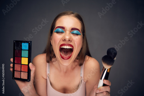 Crazy make up artist with clown worst make up.