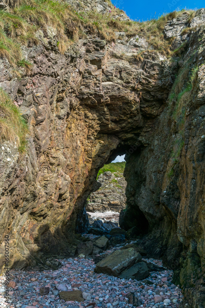 Cave through rock.