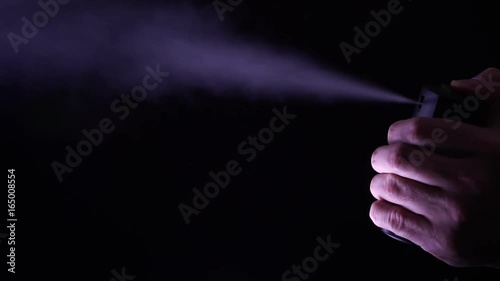 Hand with bottle of pepper spray, tear gas