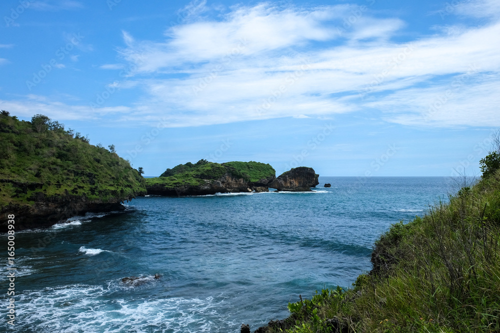 perfect destination for vacation - tropical green rocks and small islands close to the shore close to Pacitan