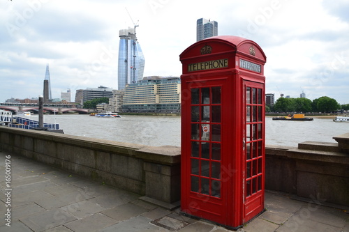 London - red telephone box and Thames river