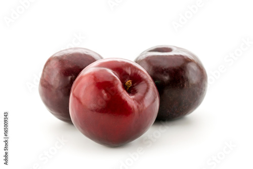 Ripe plums on white, isolated