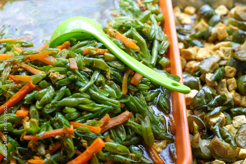 we should eat more vegetables - green plastic spoon in javanese bean - carrot - tofu salad we should eat more vegetables - green plastic spoon in javanese bean - carrot - tofu salad
