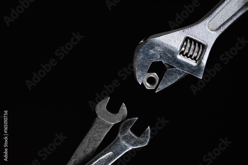 Fotografi One adjustable wrench, gives two a spanner nut on a black background