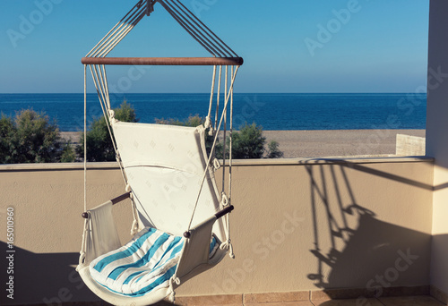A hammock on the balcony with a sea view