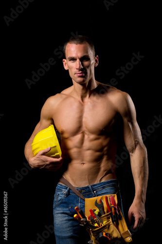fit shirtless worker with tools
