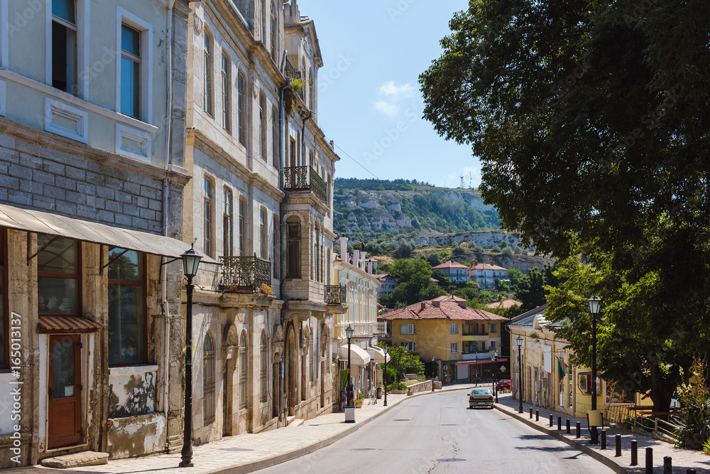 Fototapeta premium View of the street in balchik town, road and old historic houses in Bulgaria