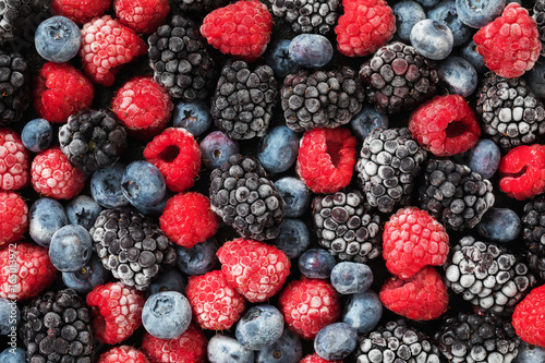 Assorted frozen berries background, top view