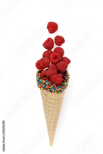 Ripe raspberries in a waffle horn isolated on white background. View from above
