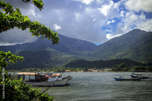 Ilhabela Sao Paulo, Brazil. Boats on the water with mountains that meet the sea in the background. This island is a popular tourist destination. 