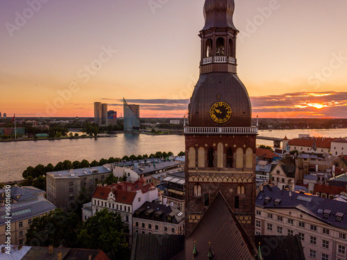 Beautiful aerial sunset view over Riga in Latvia with Huge Latvian flag in the foreground and river Daugava around the damb. photo