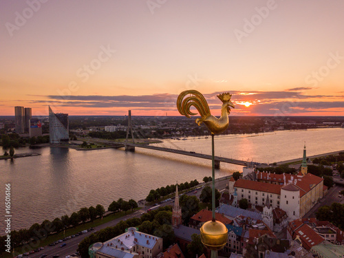 Beautiful aerial sunset view over Riga in Latvia with Huge Latvian flag in the foreground and river Daugava around the damb. photo