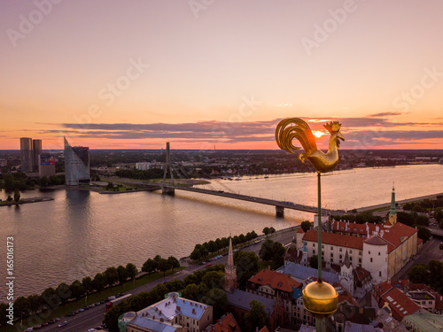 Beautiful aerial sunset view over Riga in Latvia with Huge Latvian flag in the foreground and river Daugava around the damb. photo