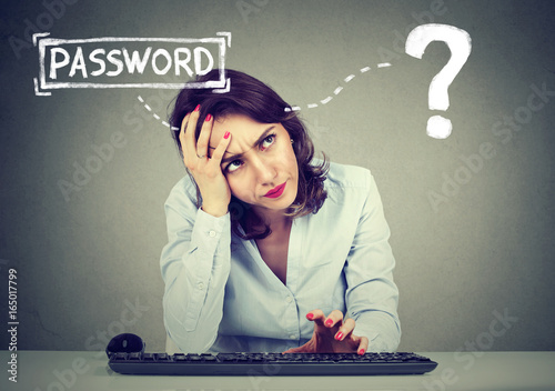 Desperate woman trying to log into her computer forgot password photo