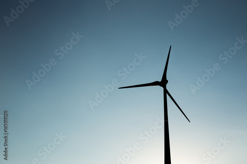 Wind turbine silhouette during sunset