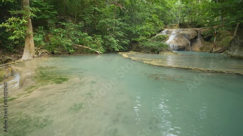 Panning shot of Level 1 of Erawan Waterfall with Neolissochilus stracheyi fish in Kanchanaburi Province, Thailand photo