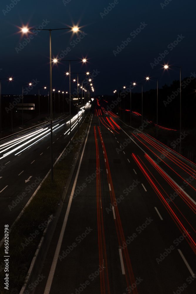 Long exposure of traffic cars lights at night on a highway