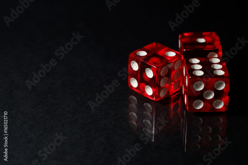 Red Sic Bo gambling dice with black isolated background photo
