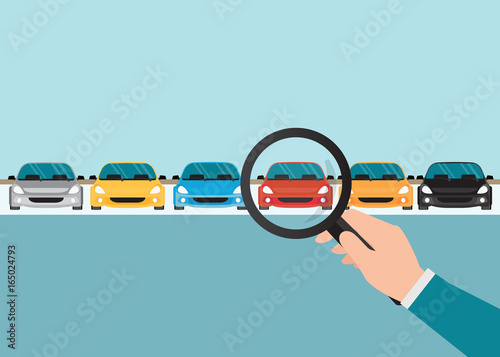 Magnifying glass in human hand with car.