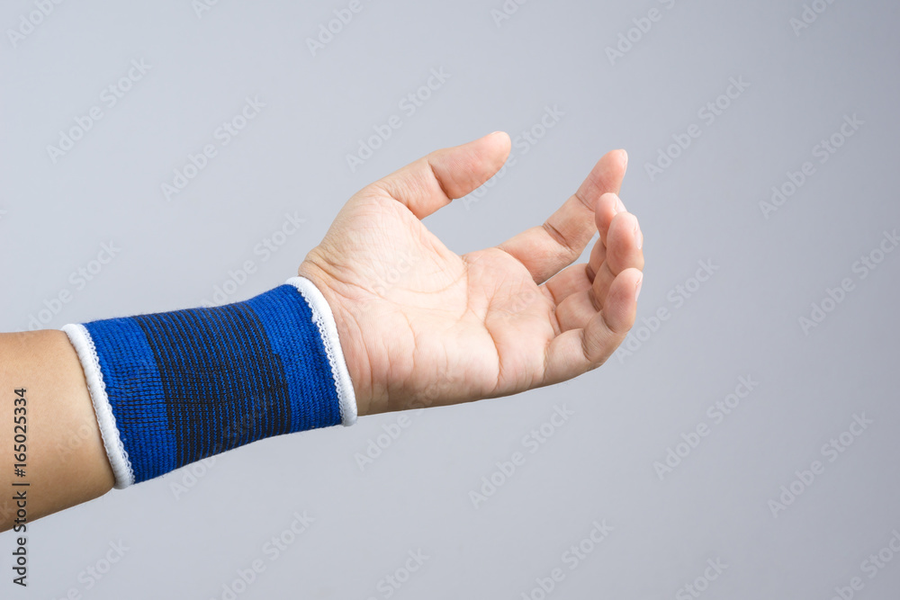 Hand with elastic wrist support and hurt gesture Hand with elastic wrist support and hurt gesture