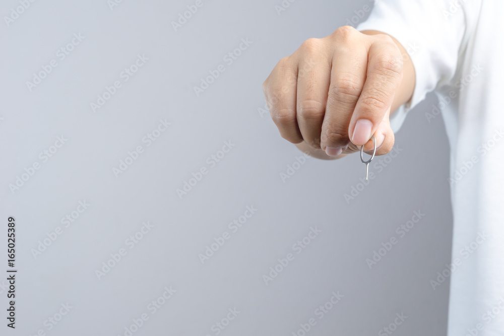 Fototapeta premium Hand holding phone sim card pin