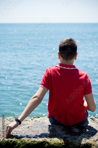 The guy sits on the seashore