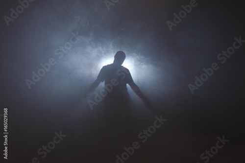 Silhouette of man in fog