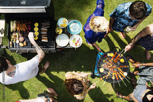 Aerial view of diverse friends grilling barbecue outdoors
