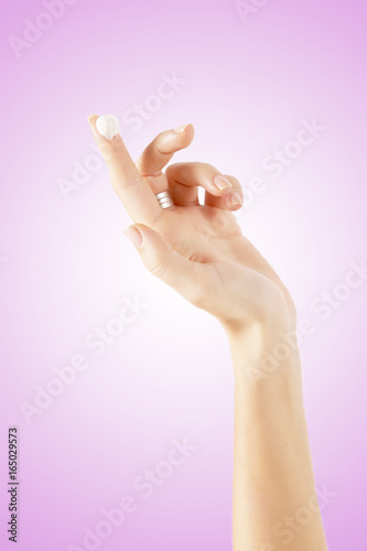 Cream on a woman's index finger