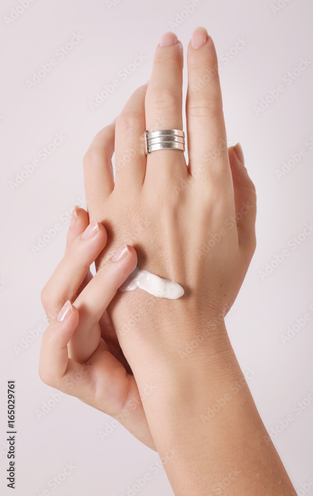 Woman applying hand cream Woman applying hand cream