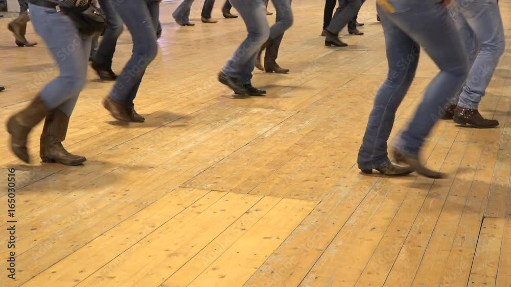 People dancing country line dance at a folk event, cowboy USA style. Legs stepping choreography American horse festival. Music tradition jeans boots and flag