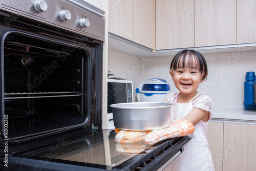 Asian Chinese little girl baking cake
