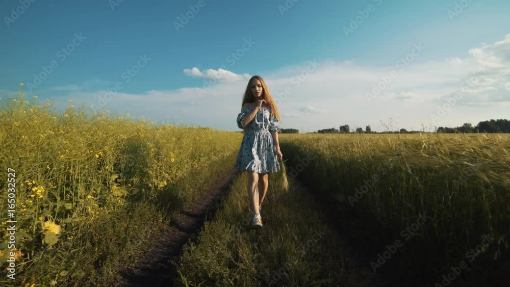 Beautiful Young Woman Walking By The Country Road
