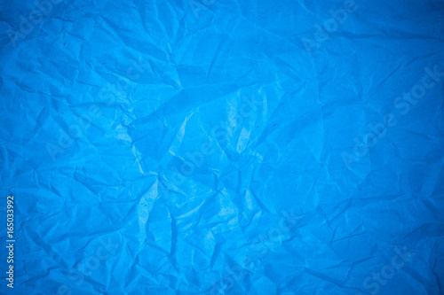 Blue paper crumpled recycle background.
