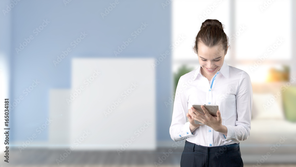 Young beautiful business woman and creative designer standing over blured interior background