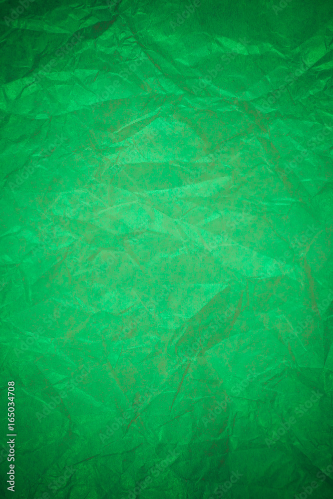 Fototapeta premium Crumpled green paper recycling background.