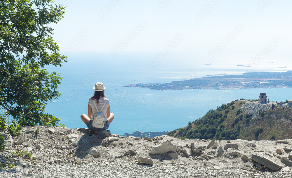 girl on the top of a mountain with sea views