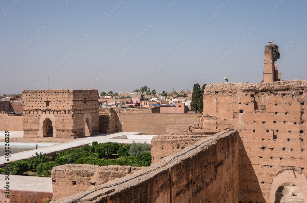 View of courtyard of El Badi Palace (Palais El Badi) in Marrakech with storks on roof , Morocco