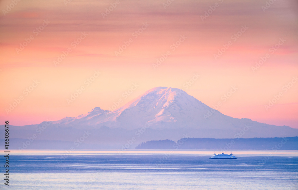 A ferry crossing the Puget Sound at sunrise with Mount Rainier in the background, Washington, USA