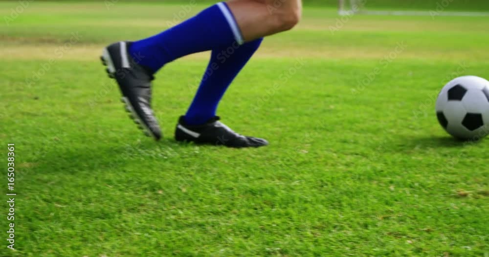 Football player playing football in the field Football player playing football in the field