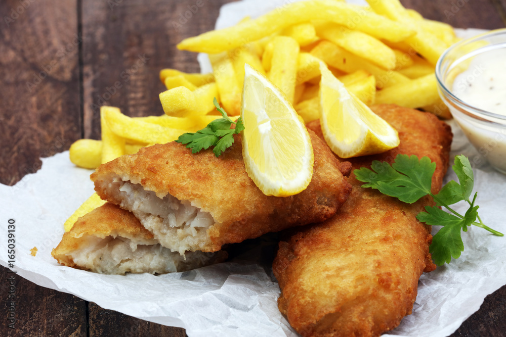 traditional British fish and chips on wooden background traditional British fish and chips on wooden background