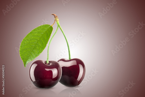 Fresh juicy cherry on a red gradient background