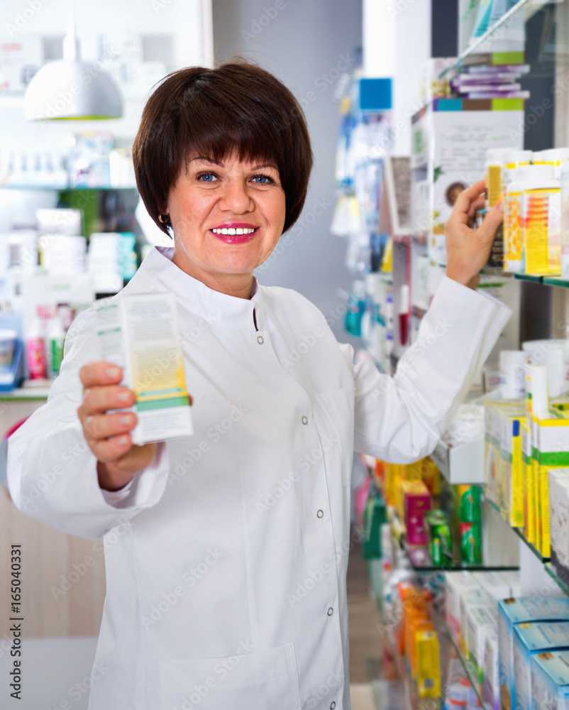 Portrait of  female druggist working in pharmacy