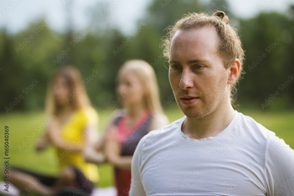 Obraz premium The yoga instructor is relaxed after classes with the group