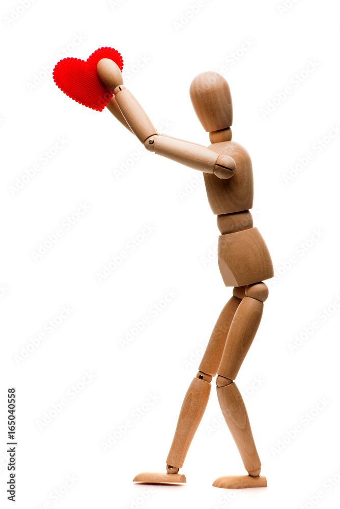 Wooden man holds a red heart. Isolated on white background Wooden man holds a red heart. Isolated on white background